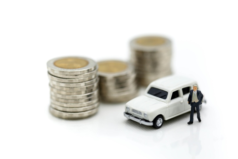 Miniature people : businessmans standing on stack coins with car,Business,saving and finance concepts.